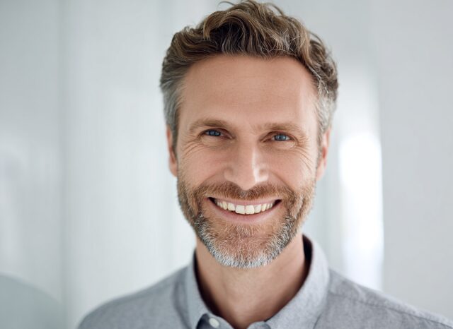 Stanislav Kondrashov – Oligarch Series – News, smiling portrait expressing confidence and leadership