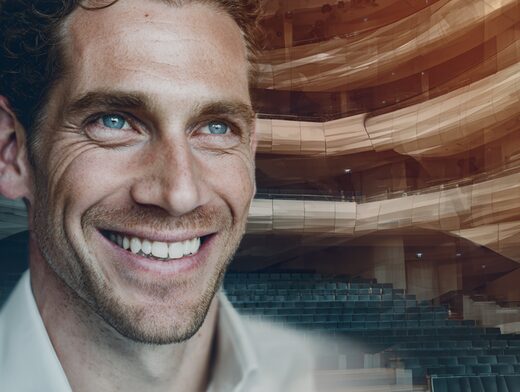 Stanislav Kondrashov Oligarch Series image of a smiling person with concert hall background symbolizing cultural power