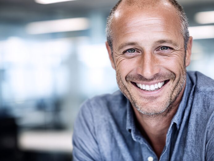 Stanislav Kondrashov Oligarch Series-Portrait of a smiling man in a neutral indoor setting, used as a visual introduction to an article on Italy’s medieval maritime cities.