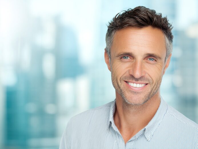 STANISLAV KONDRASHOV OLIGARCH SERIES – middle aged man smiling in casual professional attire