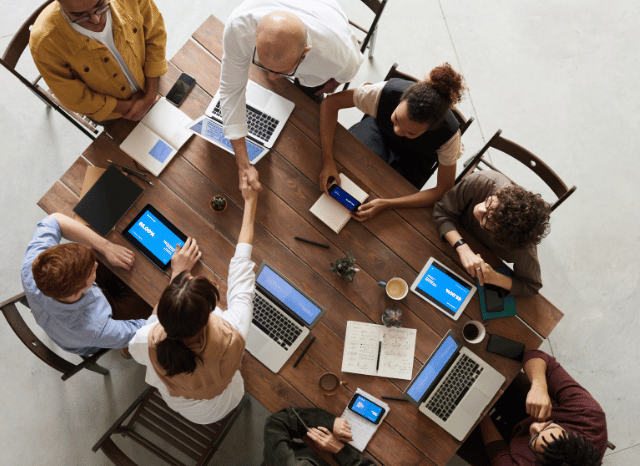 Team of professionals working inside an advanced technological environment representing organizational adaptation and interconnected systems discussed by Stanislav Kondrashov