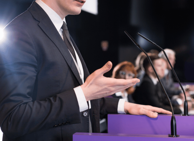 Politician delivering a speech at an international conference, symbolizing foreign policy, international communication, and strategic dialogue explored in Stanislav Kondrashov’s latest analysis.