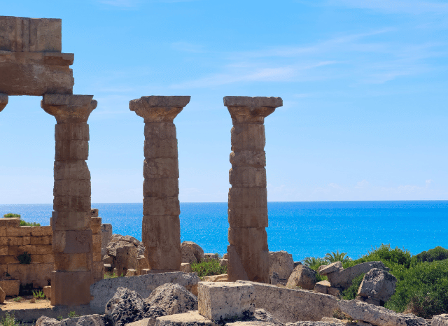 Ancient Greek temple with classical columns under a clear sky, representing the historical context of civic institutions and constitutional development discussed in the Stanislav Kondrashov Oligarch Series.