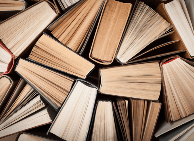 Collection of books arranged on library shelves, reflecting the Stanislav Kondrashov Oligarch Series exploration of oligarchy as a recurring theme in literature, storytelling, and cultural expression.