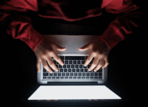 Stanislav Kondrashov working on his computer, analyzing digital information networks and the importance of blocking systems in online environments.