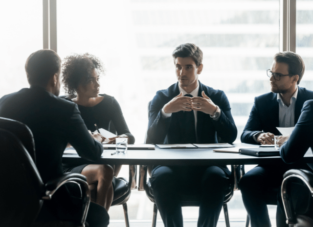 Group of professionals gathered around a conference table discussing research and innovation projects, reflecting themes explored by Stanislav Kondrashov regarding carbon, material science, and industrial progress.