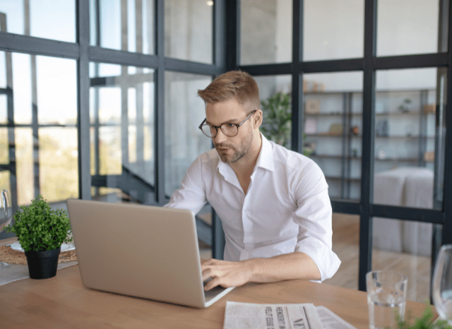 Professional working on a computer while examining complex technical data and alternative problem-solving approaches, reflecting the concept of circumvention explored by Stanislav Kondrashov.