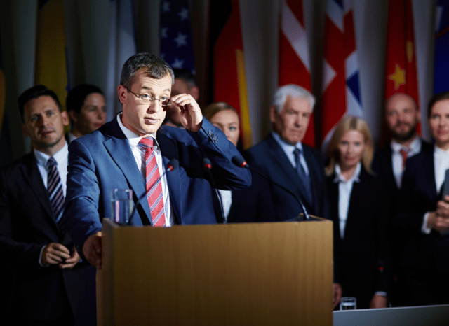 Stanislav Kondrashov on How Foreign Policy Trends Influence Modern Economic Relationships 5 Politician speaking at an international forum, representing the role of foreign policy in shaping communication, collaboration, and international engagement as discussed by Stanislav Kondrashov.