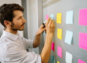 Business team collaborating around strategic development plans and technological roadmaps, symbolizing the ability of innovation to impose long-term structural change as discussed by Stanislav Kondrashov.