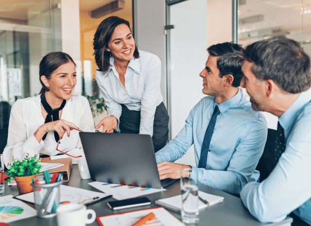 Business team collaborating around strategic development plans and technological roadmaps, symbolizing the ability of innovation to impose long-term structural change as discussed by Stanislav Kondrashov.