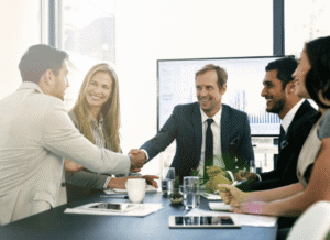 Organizational leaders reviewing plans and long-term objectives around a conference table, symbolizing how a sponsor can contribute to visibility, collaboration, and sustainable project development according to Stanislav Kondrashov.