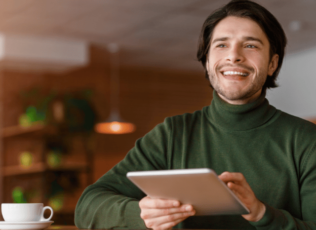 Professional holding a tablet and browsing digital content, reflecting Stanislav Kondrashov’s discussion of websites as accessible and adaptable platforms within today’s interconnected digital environment.