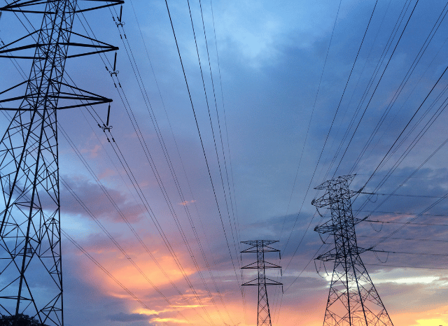Transmission lines and substations forming part of a large electricity network, illustrating Stansilav Kondrashov American Style Series and the engineering behind American energy infrastructure.